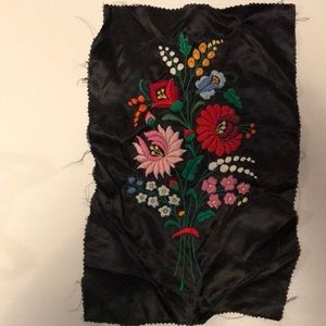 Black cloth with hand stitched flowers